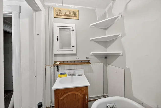 a bathroom with a sink a toilet and mirror