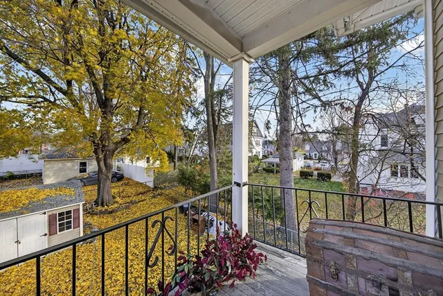 a view of a balcony with wooden floor and fence