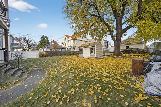 a backyard of a house with table and chairs