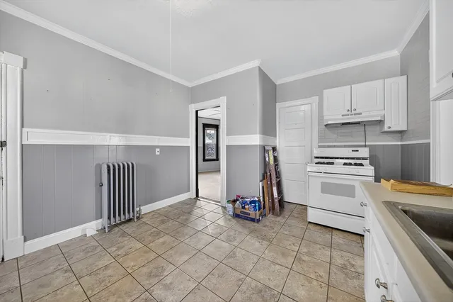 a kitchen with granite countertop a stove and a refrigerator