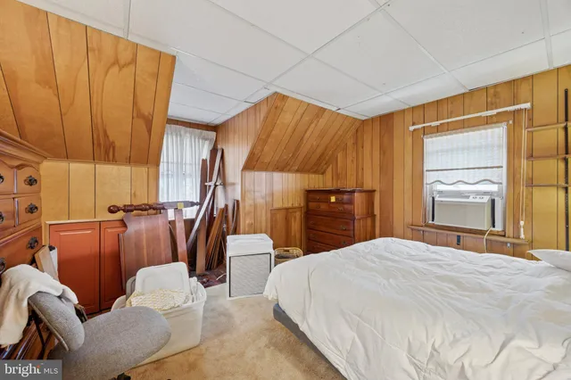 a bedroom with a bed and a television