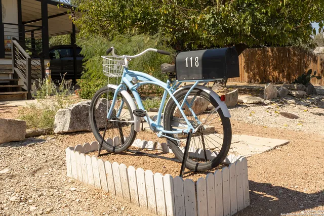 a picture of street view with wooden fence and plants
