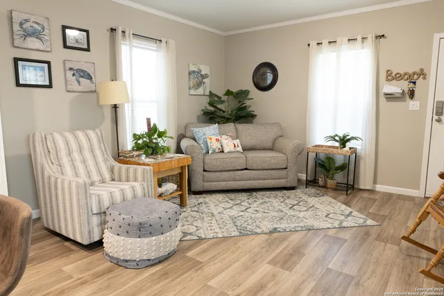 a living room with furniture rug and a window