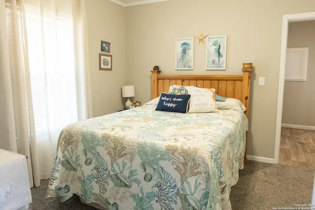a large bed sitting in a bedroom next to a window