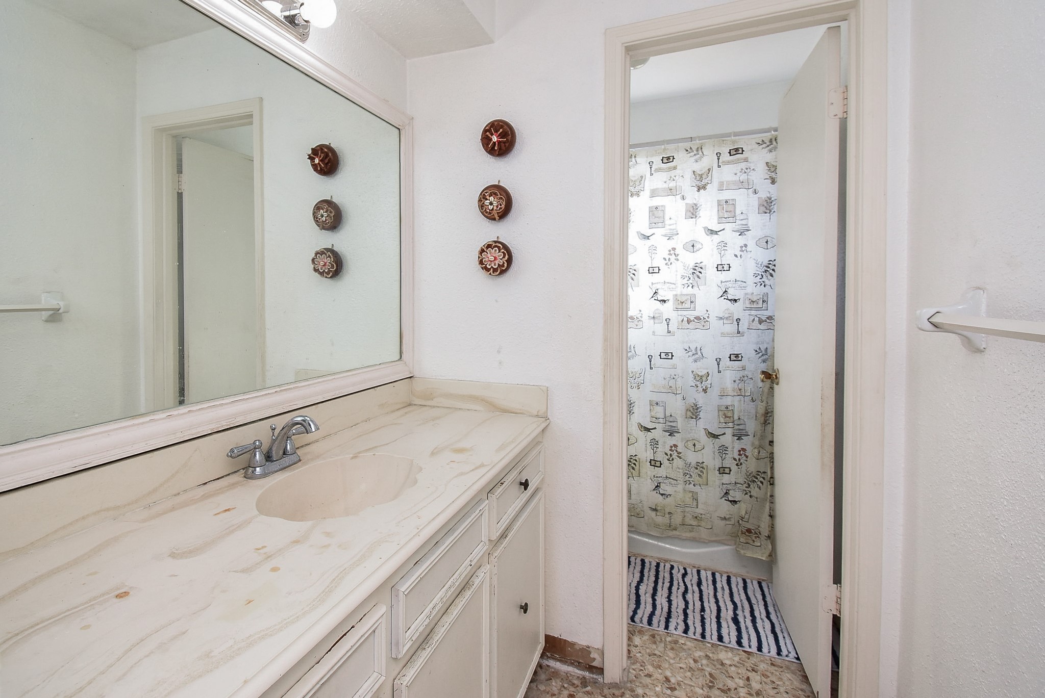 9703 Harrowgate Drive Houston, TX 77031 - Photo 20 of 32 The guest bathroom. The sink is separated from the toilet/tub area. There is plenty of storage and counter space.