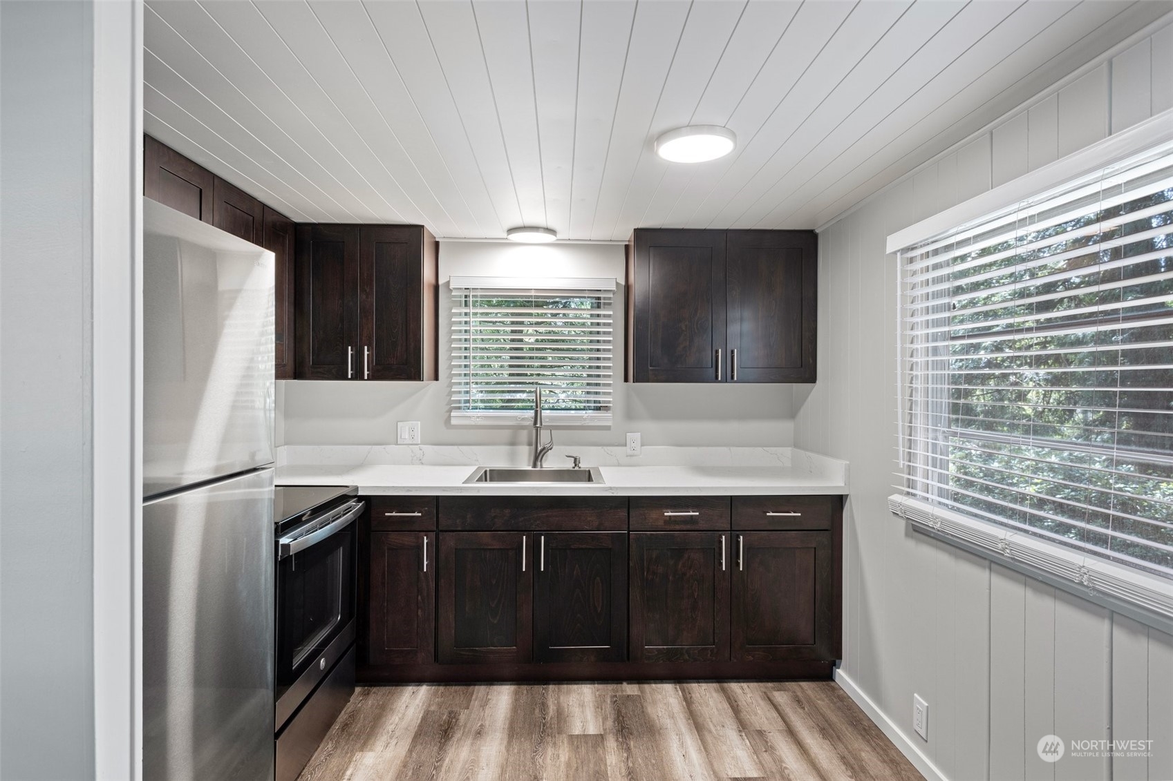 23800 Tiger Mountain Road Southeast, Unit 39 Issaquah, WA 98027 - Photo 5 of 15 a kitchen with a sink window and refrigerator