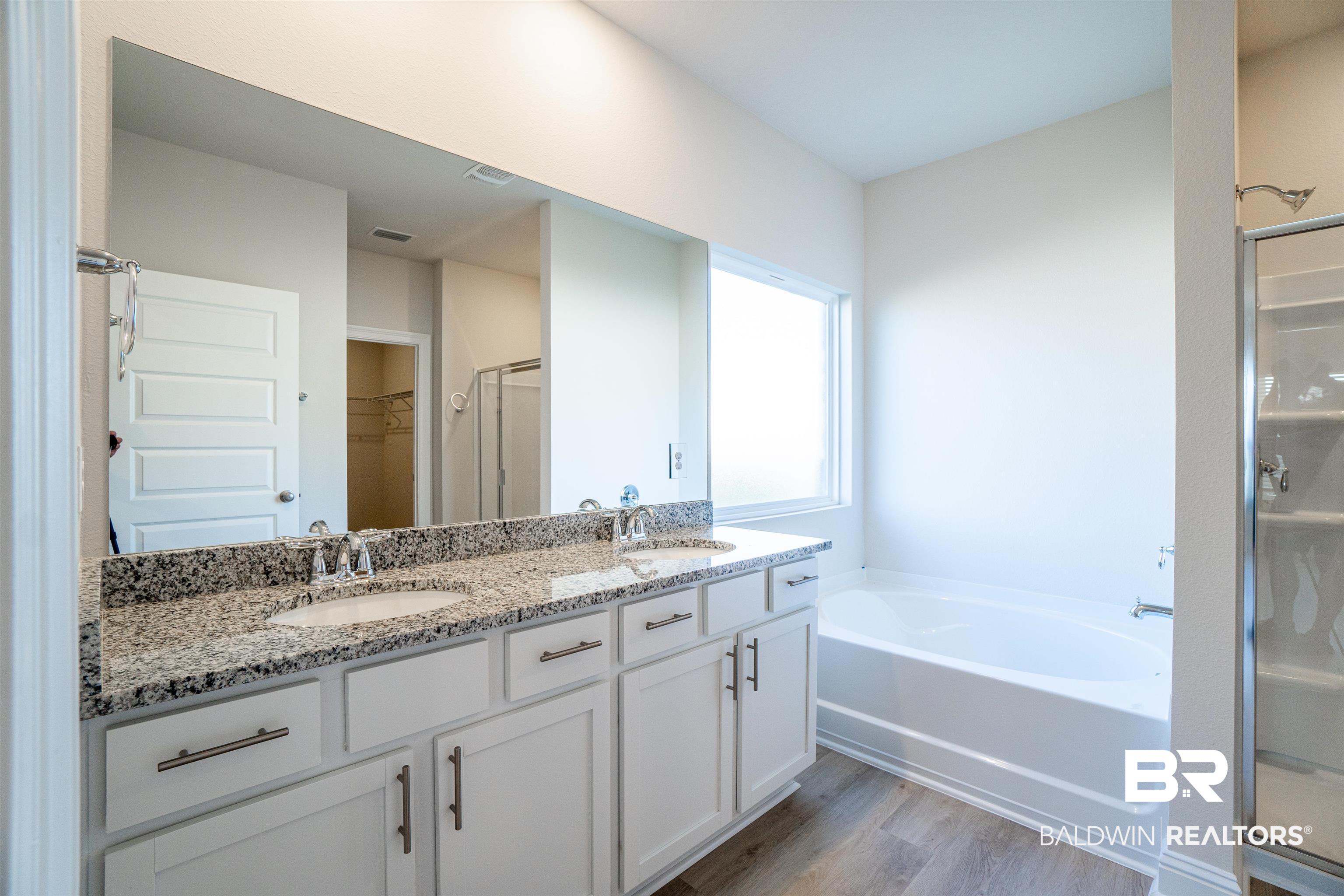 1073 Hayward Loop Foley, AL 36535 - Photo 11 of 18 Double vanity with granite countertop, undermount sinks, and brushed nickel fixtures