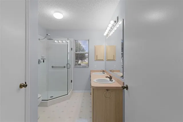 a bathroom with a sink a mirror and shower
