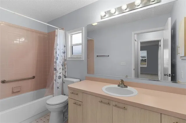 a bathroom with a sink toilet a mirror and shower