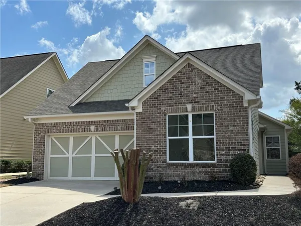 a view of a house with a large window and potted plants