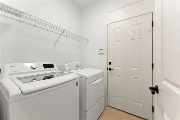 an empty room with wooden floor ceiling fan and windows