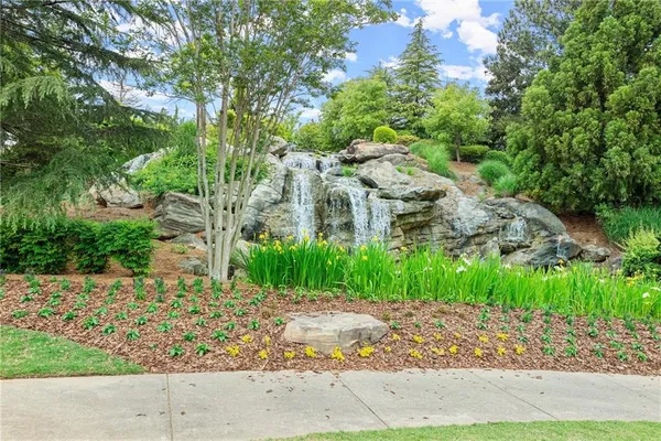 a living room with furniture chandelier and a rug