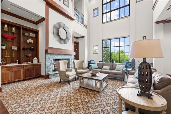 a living room with furniture tv and a floor to ceiling window