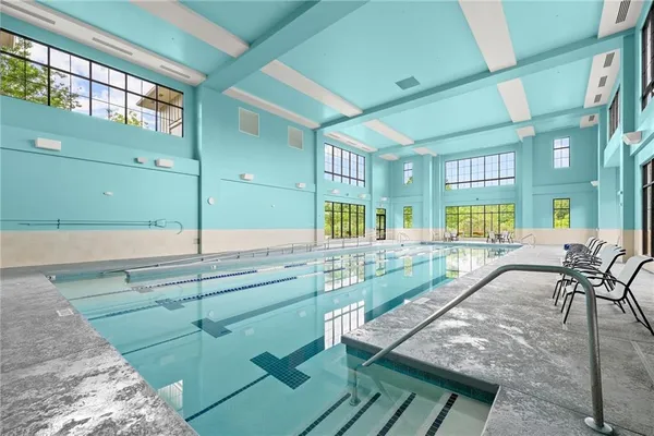 a view of a swimming pool with a lounge chair