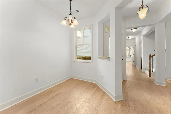 a view of a livingroom with a fireplace a chandelier fan and windows