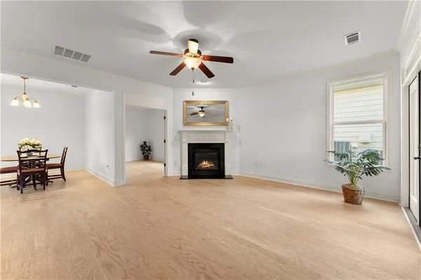 an empty room with window and a ceiling fan
