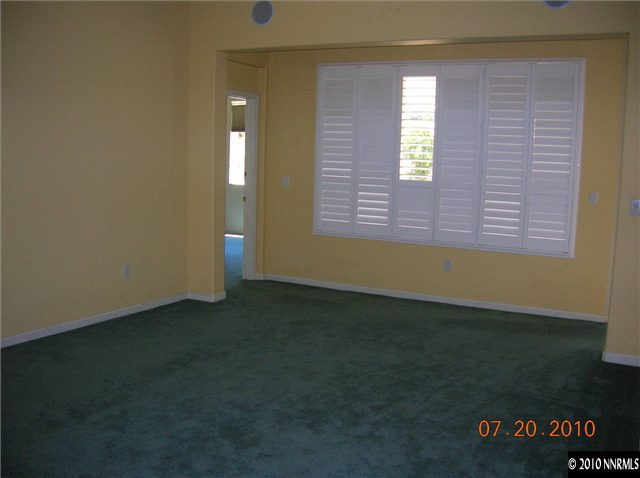 1340 Sterling Crest Lane Reno, NV 89521 - Photo 3 of 9 an empty room with wooden floor and windows