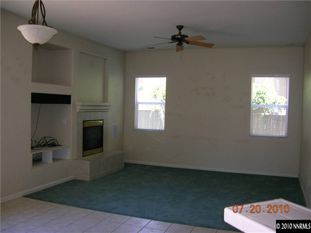 1340 Sterling Crest Lane Reno, NV 89521 - Photo 5 of 9 a living room with furniture and a fireplace