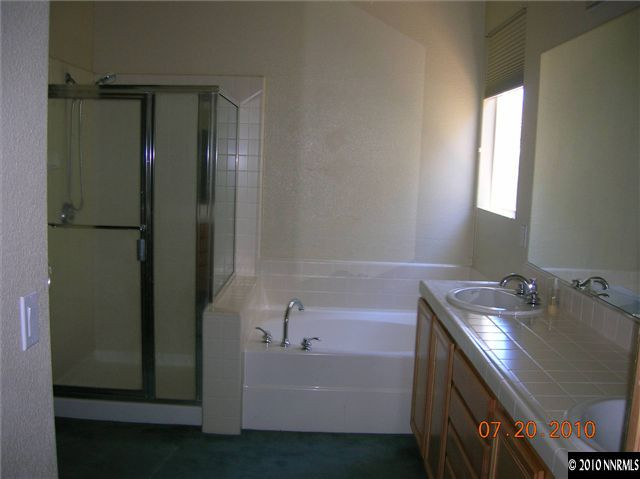 1340 Sterling Crest Lane Reno, NV 89521 - Photo 7 of 9 a bathroom with a tub sink and mirror