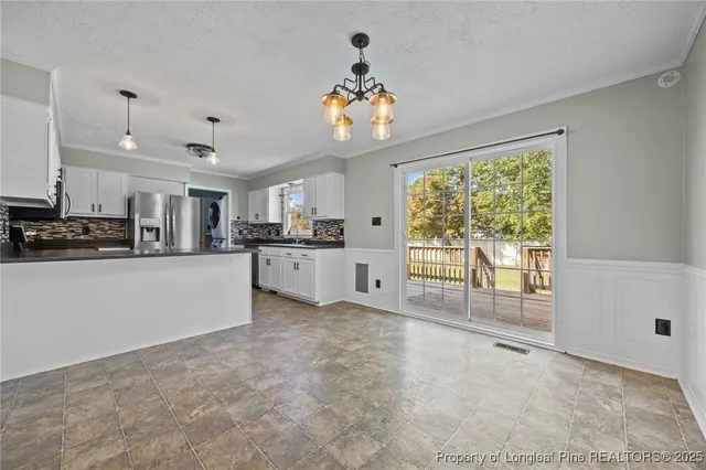 a view of a kitchen with microwave and cabinets