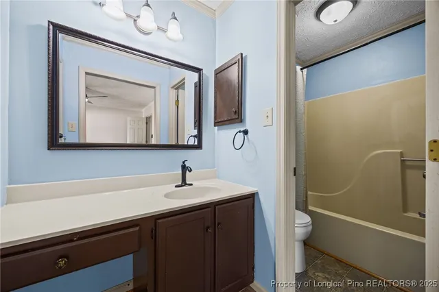 a bathroom with a sink a toilet a mirror and shower