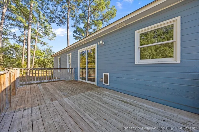 a view of backyard with deck and wooden floor