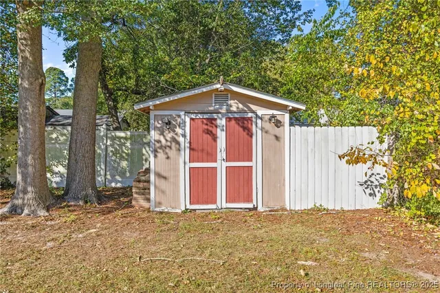 a front view of a house with a tree