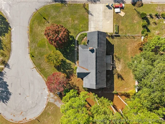 an aerial view of a house with a yard