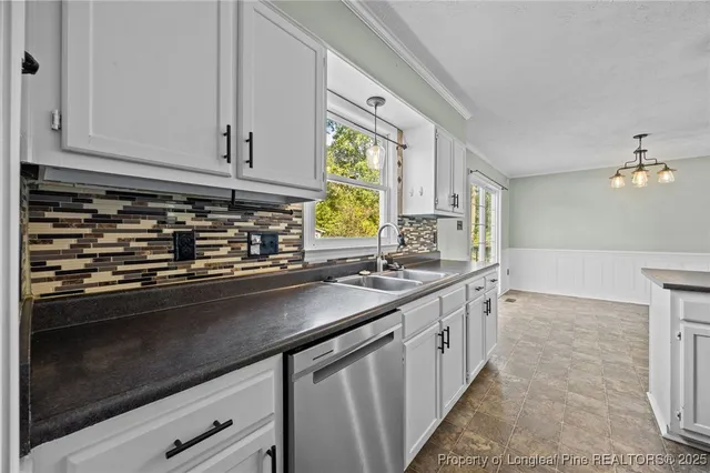 a kitchen with stainless steel appliances granite countertop a sink a stove and a granite counter tops