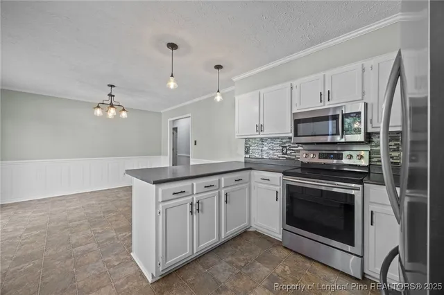 a kitchen with granite countertop a stove top oven a sink and dishwasher