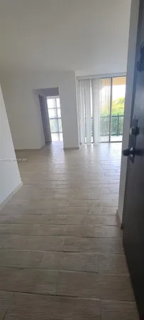 a view of hallway with window and wooden floor