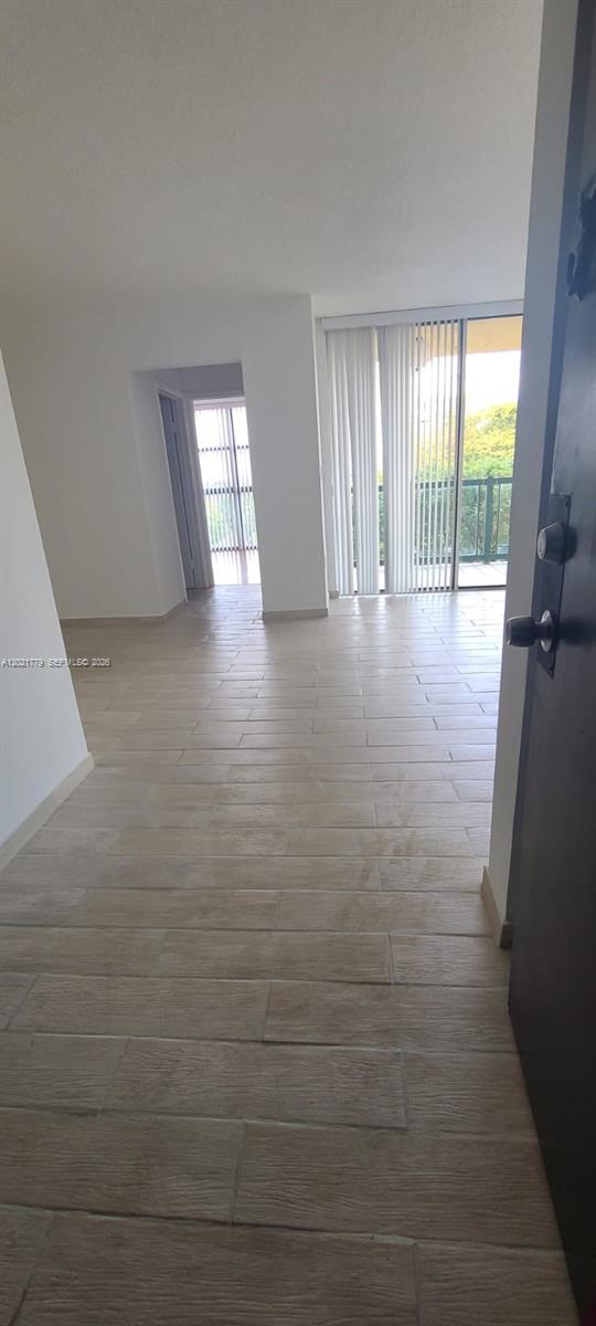 11800 Southwest 18th Street, Unit 4094 Miami, FL 33175 - Photo 1 of 14 a view of hallway with window and wooden floor