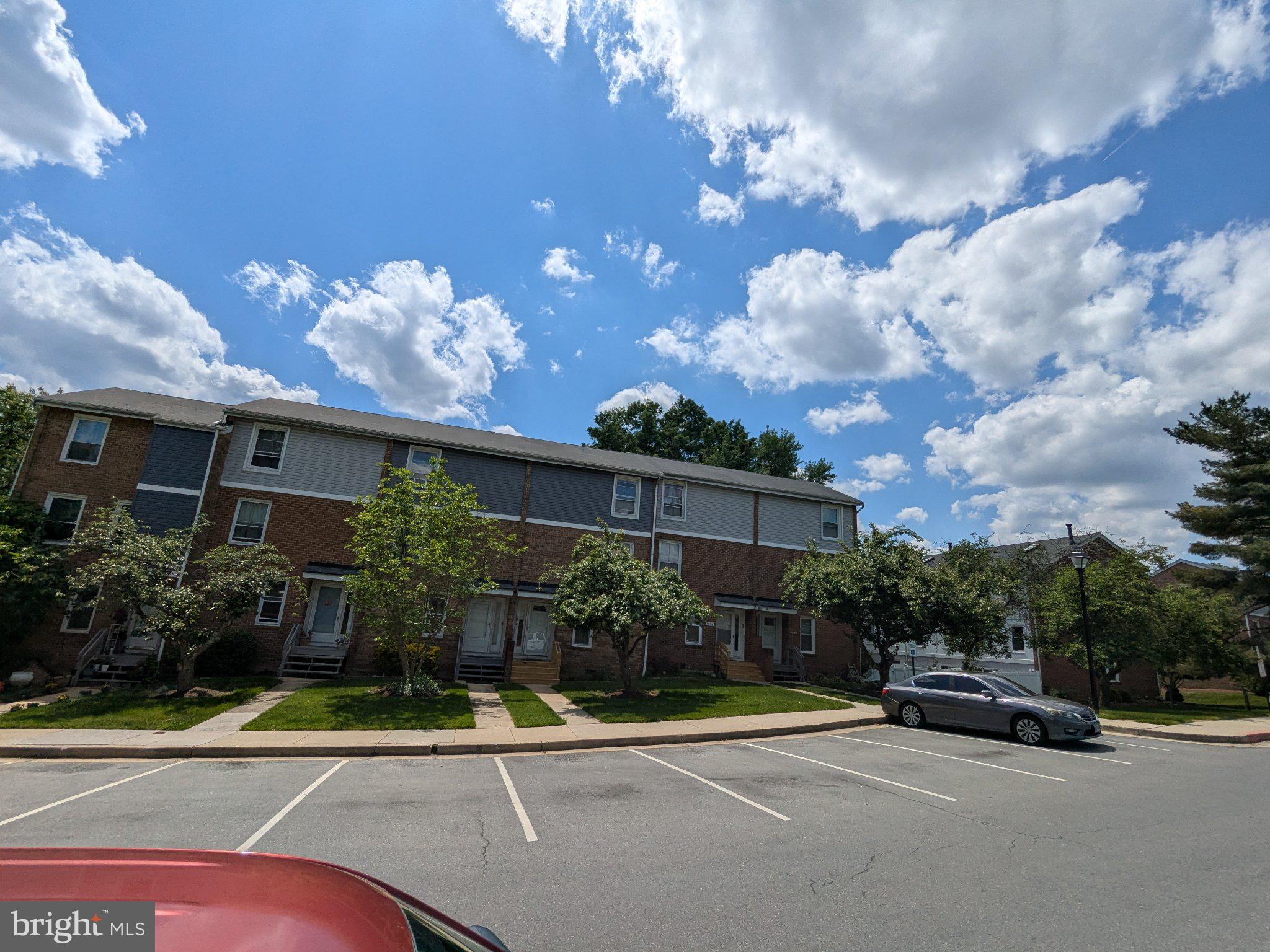 9054 Canterbury Riding, Unit 147 Laurel, MD 20723 - Photo 3 of 3 Charming townhomes under a blue sky.