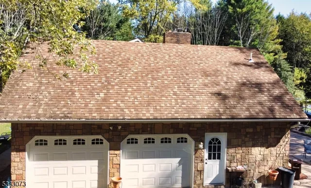 a view of a hallway with a white cabinet and a window