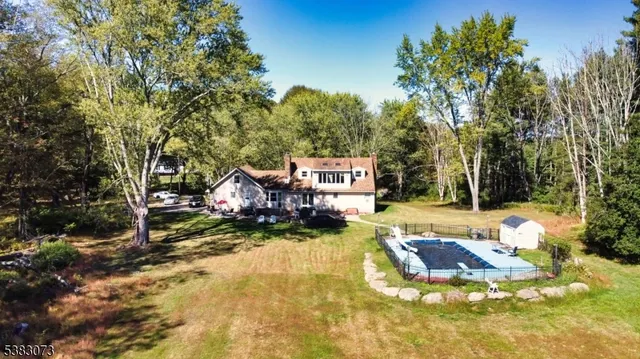 a view of a hallway with wooden floor and stairs