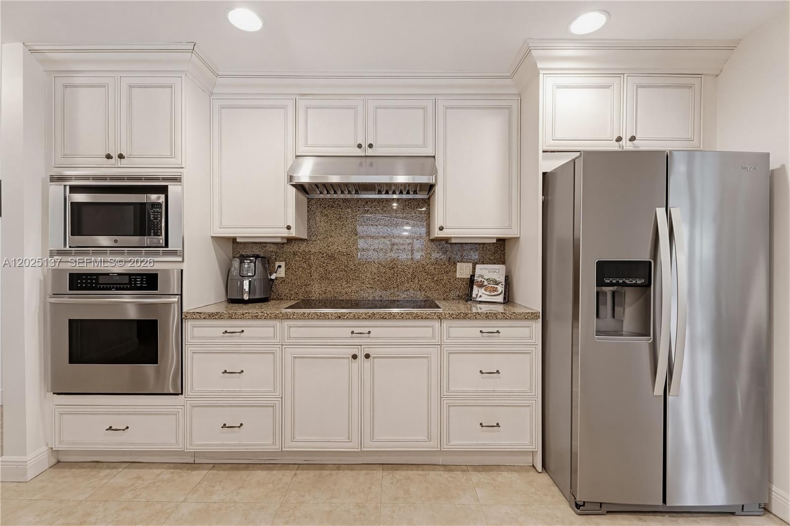 11480 Southwest 96th Terrace Miami, FL 33176 - Photo 13 of 54 a kitchen with granite countertop white cabinets and stainless steel appliances