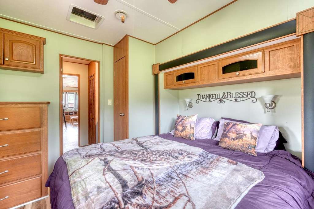 568 Parks Road Hiawassee, GA 30546 - Photo 20 of 38 a bedroom with a bed and a night stand