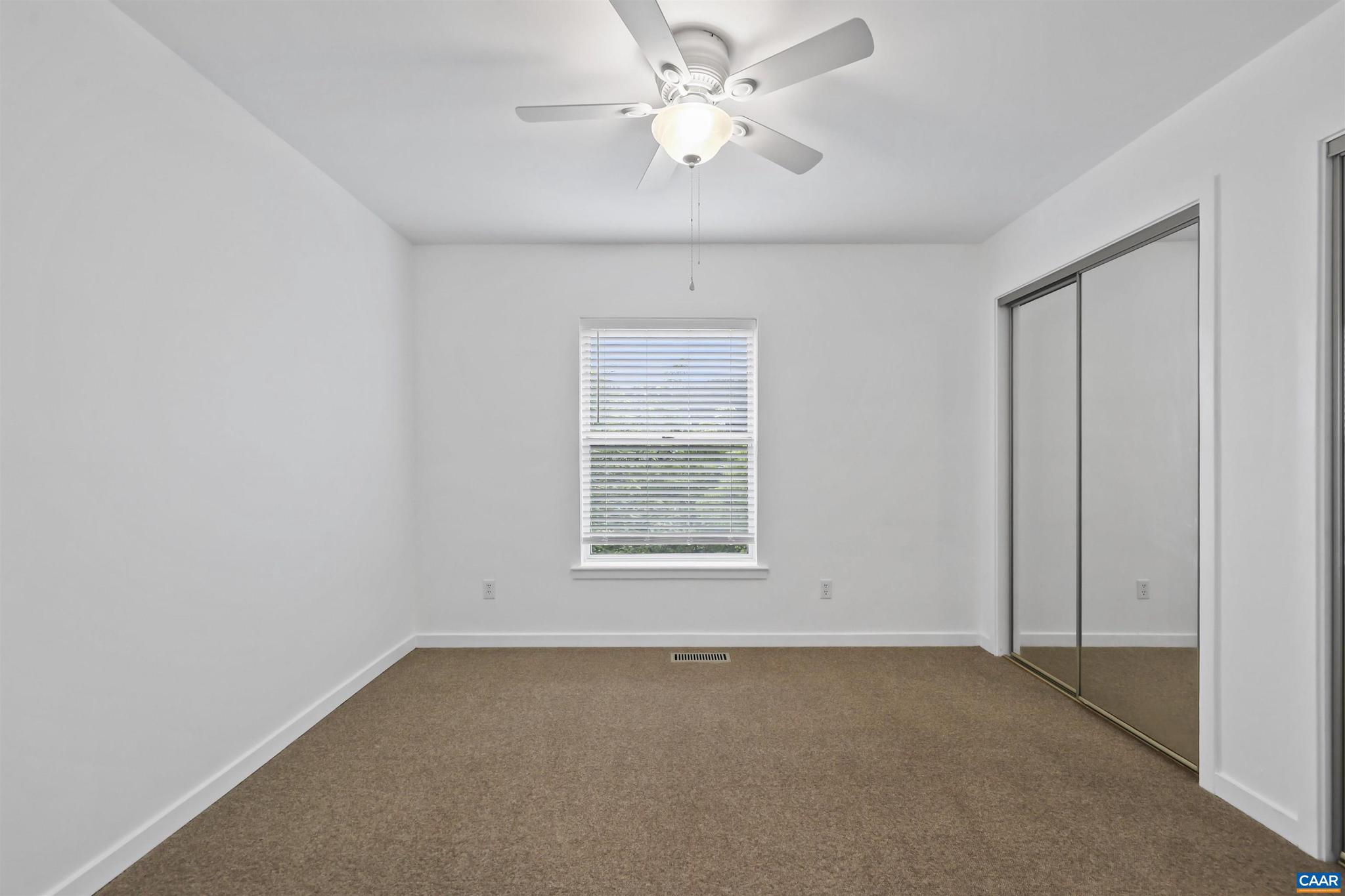 1250 Maple View Drive Charlottesville, VA 22902 - Photo 18 of 25 an empty room with a window and a fan