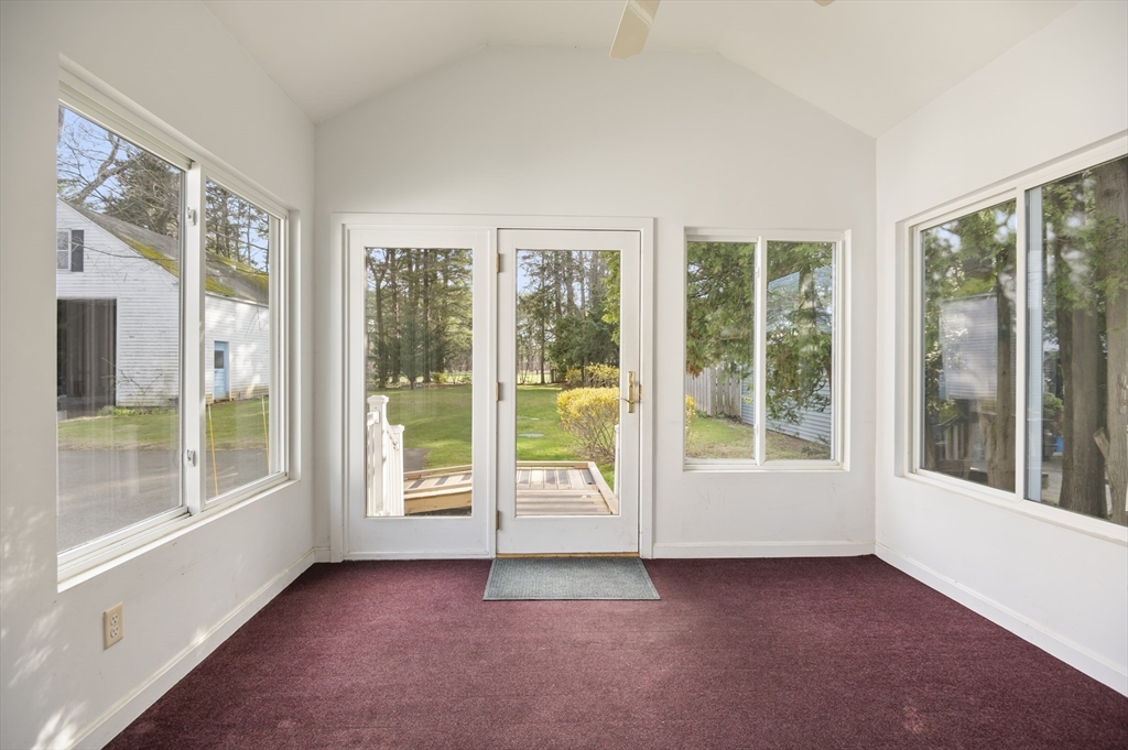 110 Linden Street Hamilton, MA 01982 - Photo 12 of 25 a view of an empty room with windows and a balcony