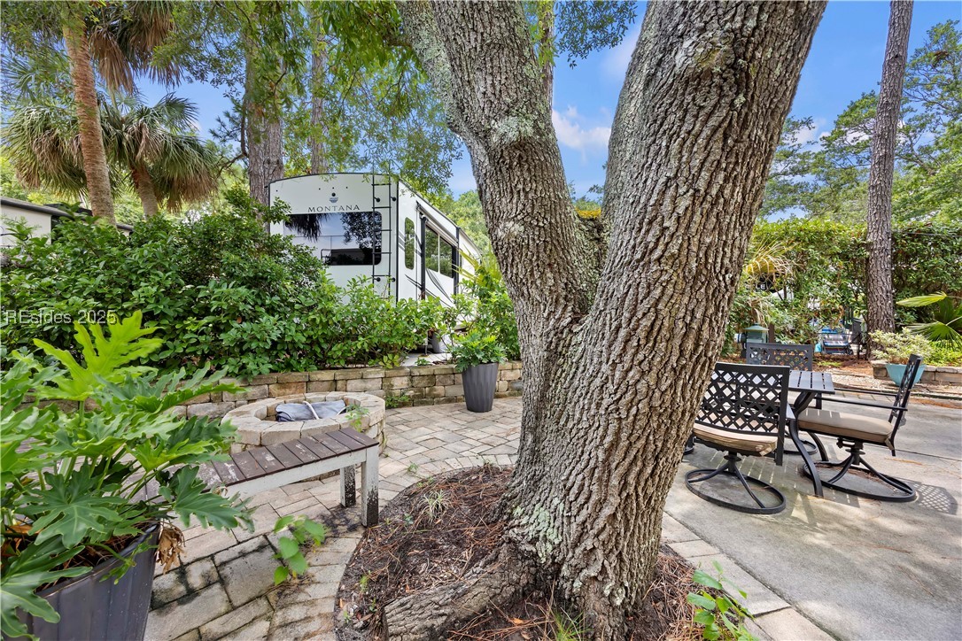 43 Jenkins Road, Unit 154 Hilton Head Island, SC 29926 - Photo 4 of 15 Beautiful mature shade trees, tranquil setting with pavers, furniture, firepit and landscaping