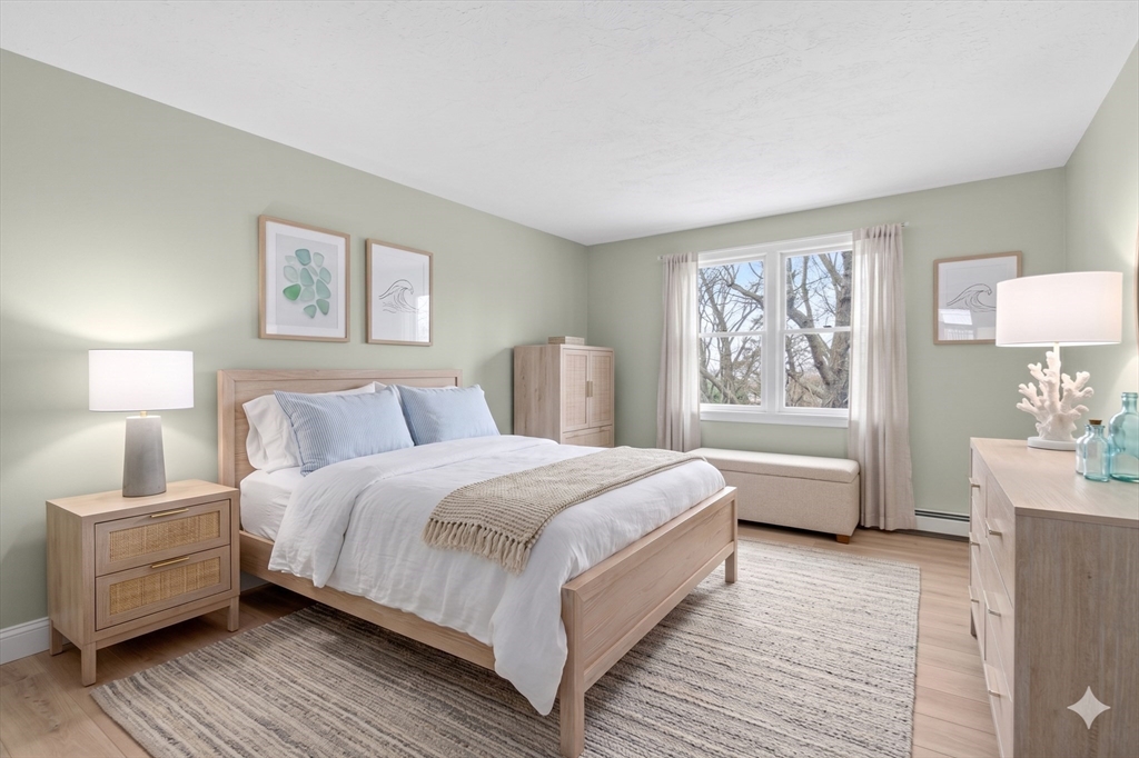 32 Howe Road Cohasset, MA 02025 - Photo 9 of 25 a spacious bedroom with a bed and a couch