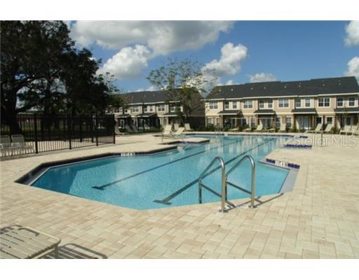 8218 Downpatrick Court, Unit 402 Tampa, FL 33610 - Photo 1 of 1 a swimming pool with outdoor seating