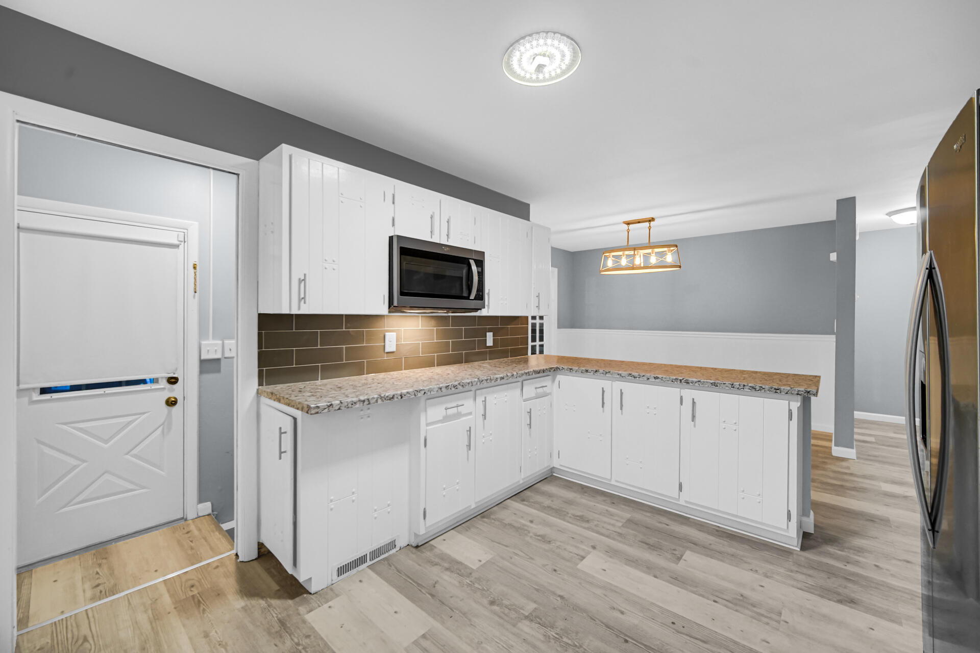 212 Timrick Drive Munster, IN 46321 - Photo 8 of 46 a kitchen with granite countertop white cabinets and stainless steel appliances