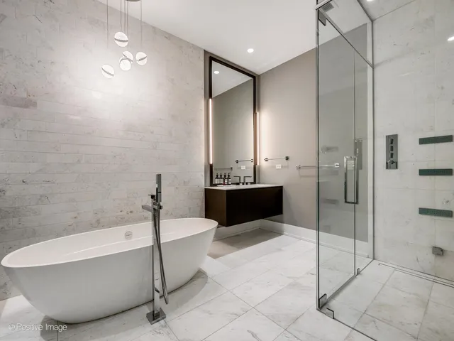 a bathroom with a bathtub and a shower