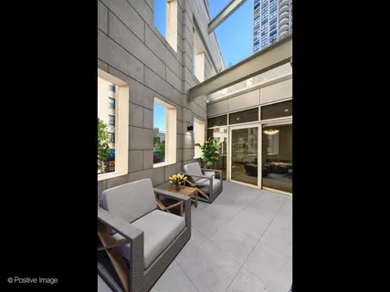 a building outdoor space with patio furniture and garden