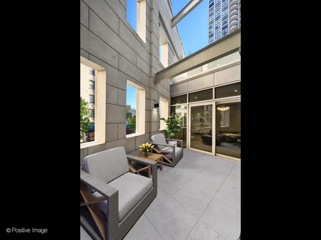 a building outdoor space with patio furniture and garden