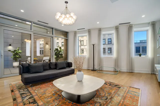 a living room with furniture and a chandelier