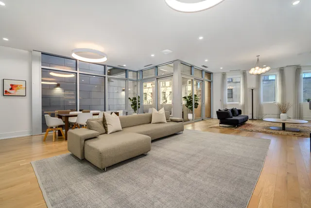 a living room with furniture a lamp and a table