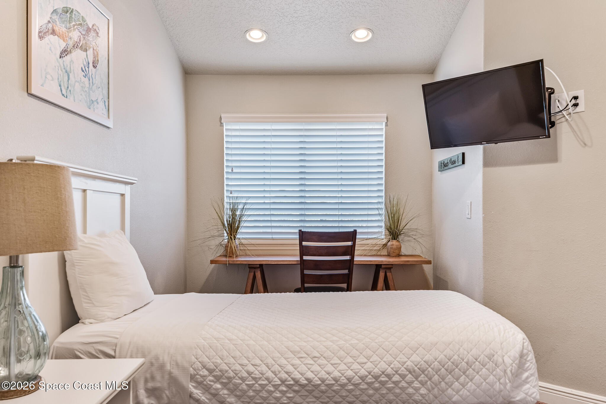 2709 Cutlass Point Lane, Unit 102 Merritt Island, FL 32953 - Photo 20 of 37 a bedroom with a bed and a flat screen tv