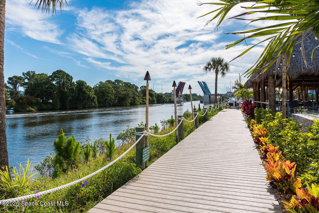 2709 Cutlass Point Lane, Unit 102 Merritt Island, FL 32953 - Photo 28 of 37 a lake view with a wooden bridge